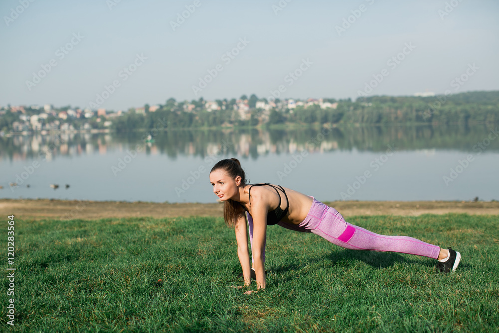 Obraz premium Girl doing yoga fitness exercise for relax and healthy at lake in morning, Nature background. Concept outdoor sport and health.