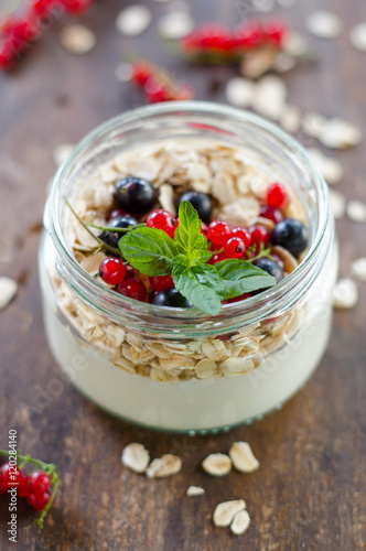 yogurt with berries and products for healthy breakfast, close-up
