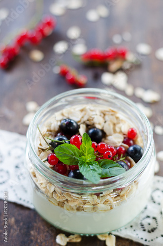 yogurt with berries and products for healthy breakfast, close-up
