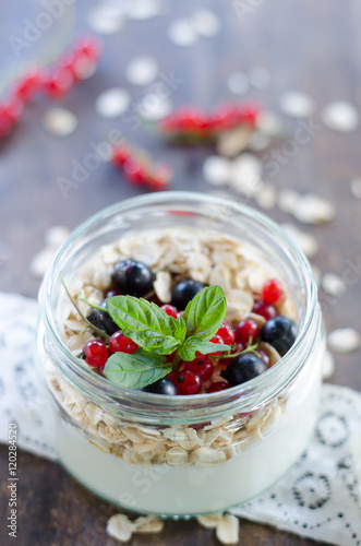 yogurt with berries and products for healthy breakfast, close-up
