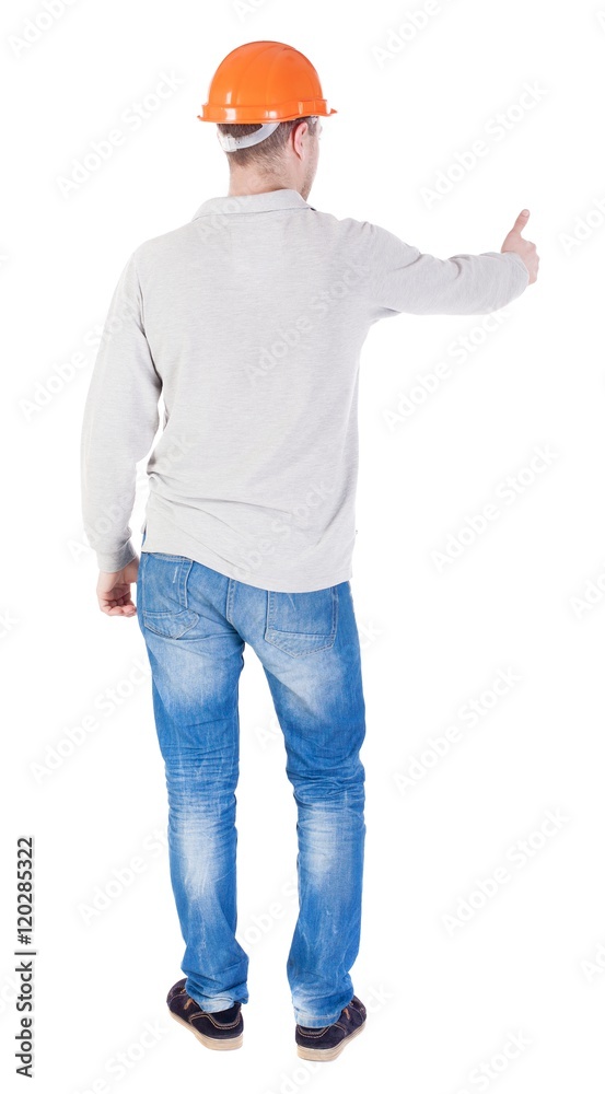 Back view of builder in helmet shows thumbs up. Rear view people collection. backside view of person. Isolated over white background. Back view of builder in helmet shows thumbs up. Rear view people collection. backside view of person. Isolated over white background.