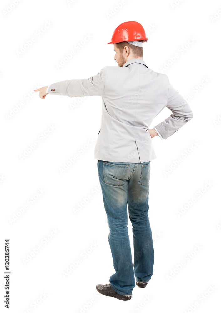 Back view of  pointing young men in helmet. Young guy  gesture. Rear view people collection.  backside view of person.  Isolated over white background. Pretty businesswoman at the facility gives the