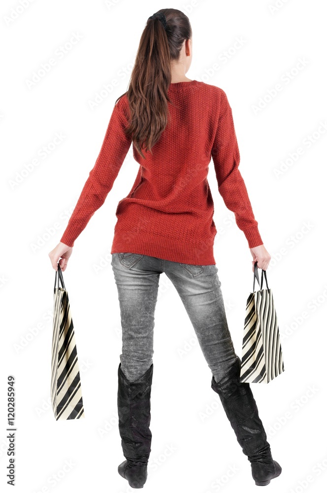 back view of going woman in sweater woman with shopping bags . beautiful brunette girl in motion. backside view of person. Rear view people collection. Isolated over white background. back view of going woman in sweater woman with shopping bags . beautiful brunette girl in motion. backside view of person. Rear view people collection. Isolated over white background.