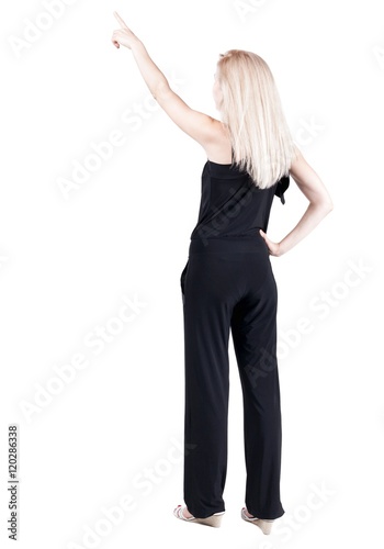 Back view of  pointing woman. beautiful blonde girl in jeans.  Rear view people collection.  backside view of person.  Isolated over white background.