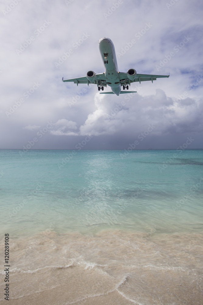 Naklejka premium Airplane Landing near Beach
