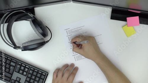 Businessman preparing checklist at office desk