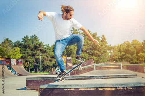 Skater jumping in skateboard park