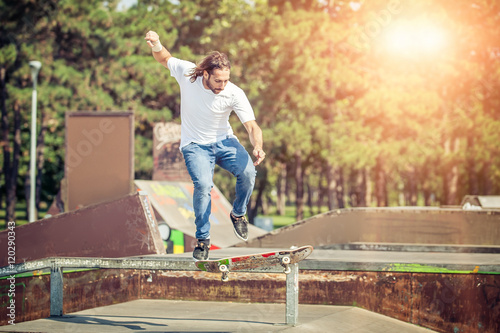 Skater jumping in skateboard park