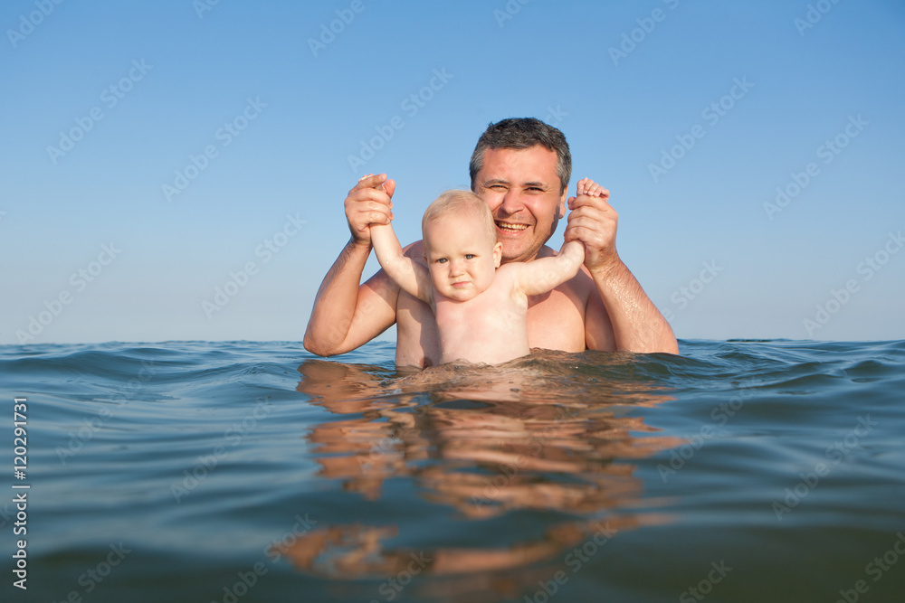 Portrait of daughter and father in the sea