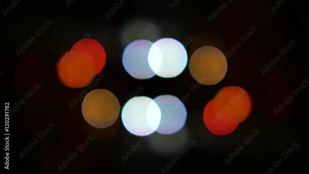 Defocused night traffic lights. Colorful bokeh circles move Defocused night traffic lights. Colorful bokeh circles move