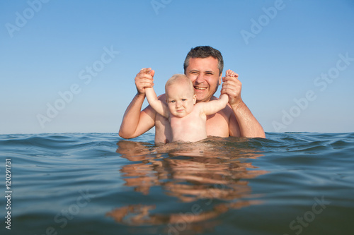 Portrait of daughter and father in the sea