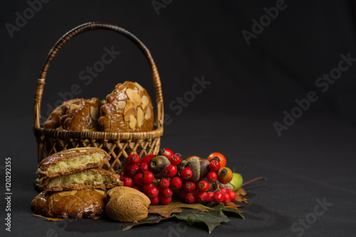 Typical Dutch filled spicy  cookies with almonds on autumn colored and dark 