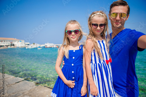 Family vacation in Europe. Father and kids taking selfie background Mykonos town in Greece © travnikovstudio