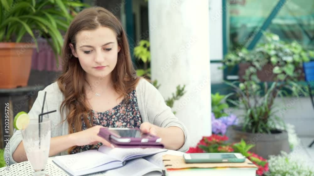 Worried girl browsing internet on tablet and looking to the camera
Worried girl browsing internet on tablet and looking to the camera
