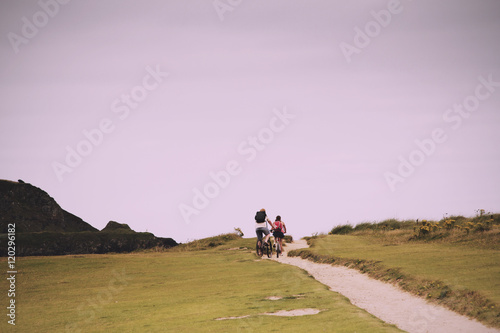 Cyclists on a costal path in Cornwall Vintage Retro Filter.