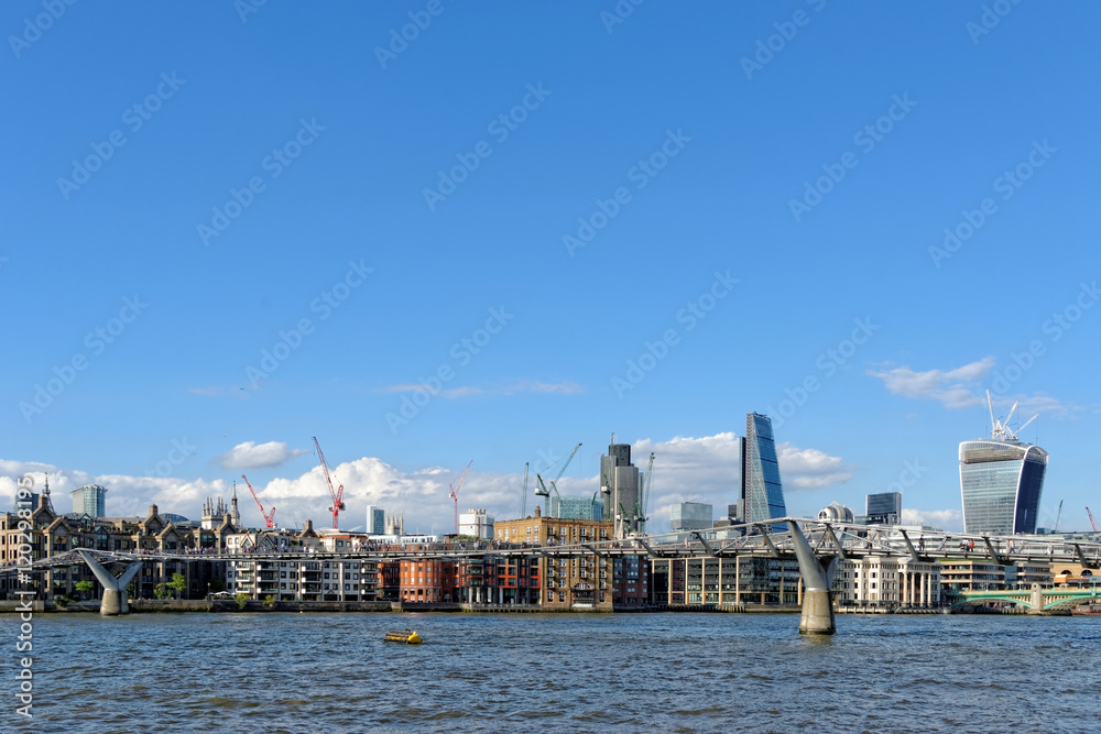 London skyline - City of London and Millennium bridge.UK.