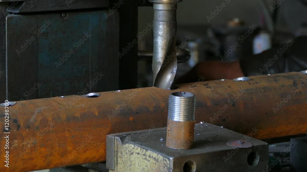 Worker Enlarging Hole In Tube With Drill Worker Enlarging Hole In Tube With Drill