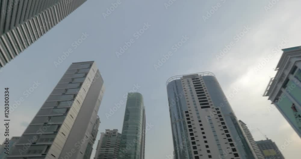 Low angle shot of city skyscrapers with following view of building cranes and construction site. Kuala Lumpur, Malaysia Low angle shot of city skyscrapers with following view of building cranes and construction site. Kuala Lumpur, Malaysia