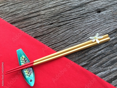 Chopstick on wood and red table cloth