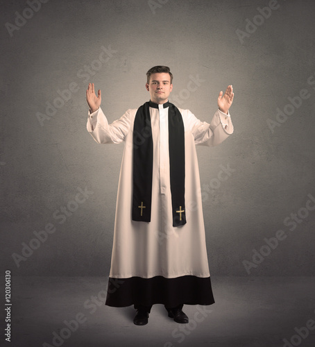 young priest in giving his blessing photo