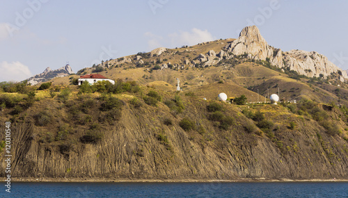 Mountain landscape: house and radar station on the coast.