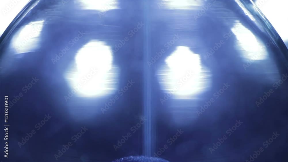 Blue Sand falling in hourglass. Extreme close-up. Blue Sand falling in hourglass. Extreme close-up.