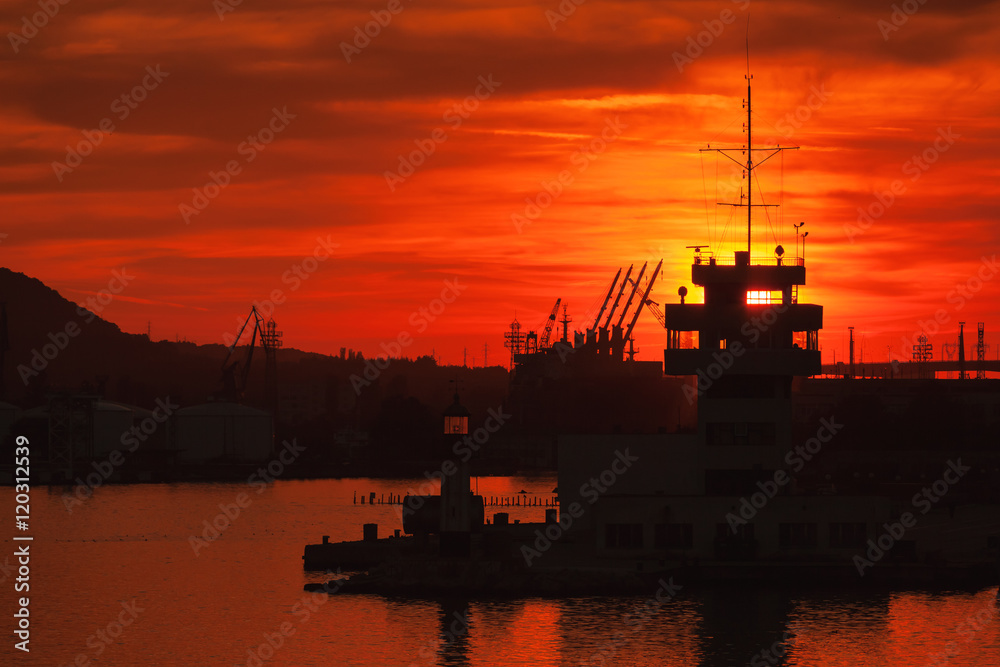 Cranes and buildings of Varna port at sunset