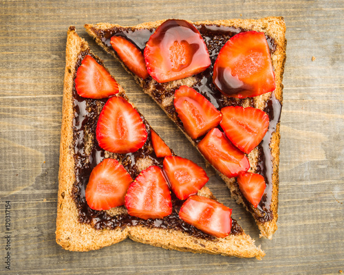 overhead shot of triangles of bread with chocolate and sliced fr photo