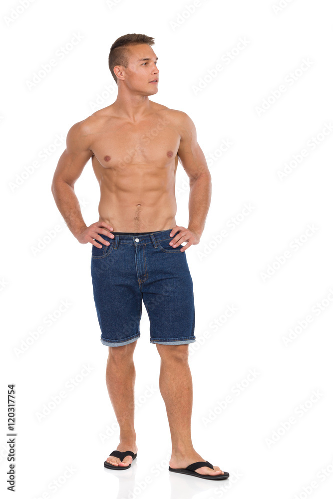Man Posing In Jeans Shorts And Sandals Man Posing In Jeans Shorts And Sandals