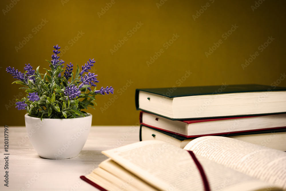 Stack of books on the table and a lavender plant Stack of books on the table and a lavender plant