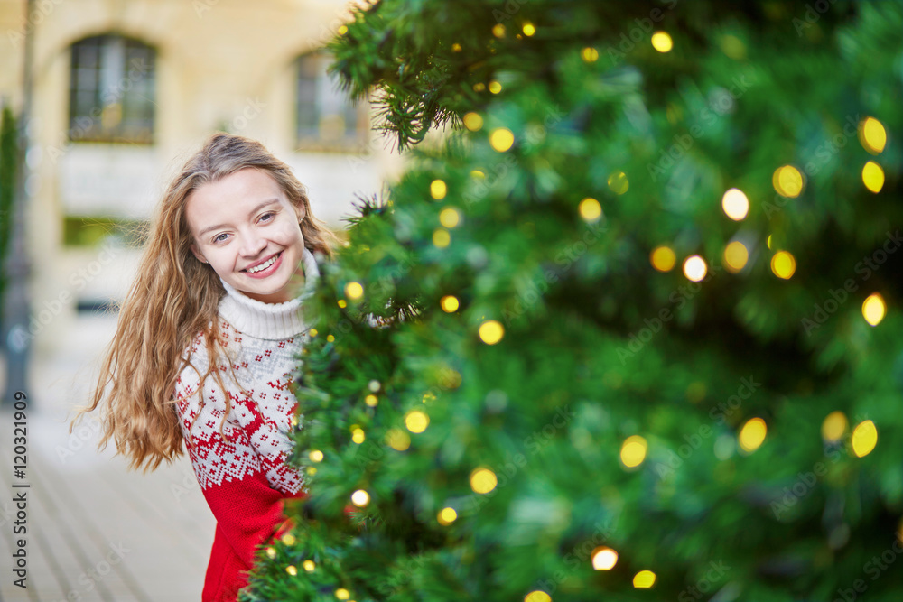 Young woman on a street of Paris decorated for Christmas Young woman on a street of Paris decorated for Christmas