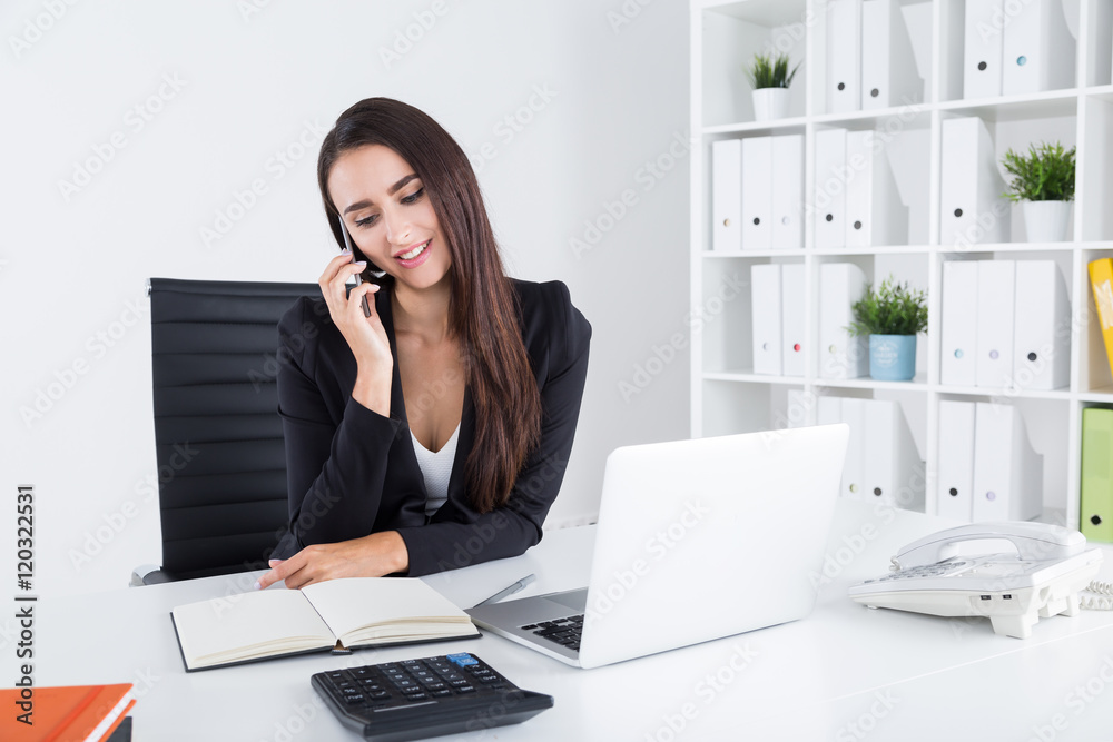 Pretty businesswoman with long hair is having phone conversation Pretty businesswoman with long hair is having phone conversation