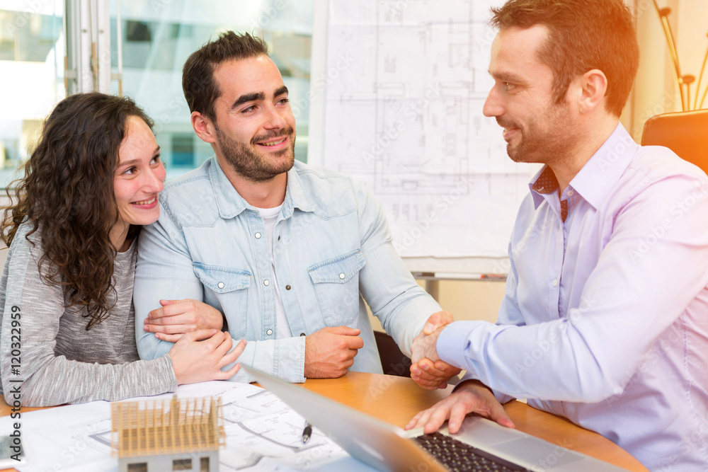 Fototapeta premium Young attractive people meeting real estate agent at the office