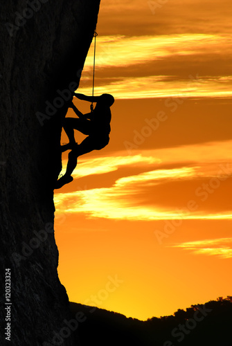 Silhouette of a climber over beautiful sunset