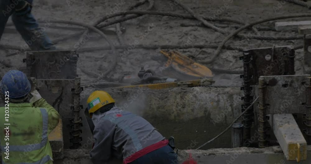 View of worker welding metal reinforcement of constructed building. Hong Kong, China View of worker welding metal reinforcement of constructed building. Hong Kong, China