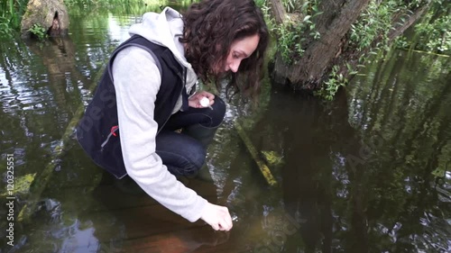View of a Young attractive biologist woman working on water analysis