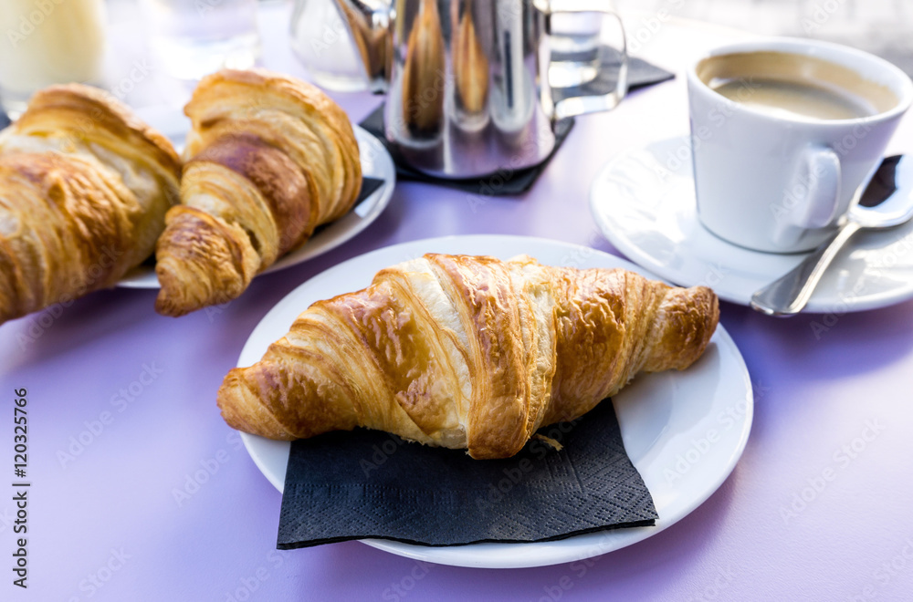 Breakfast with coffee and croissants on table Breakfast with coffee and croissants on table