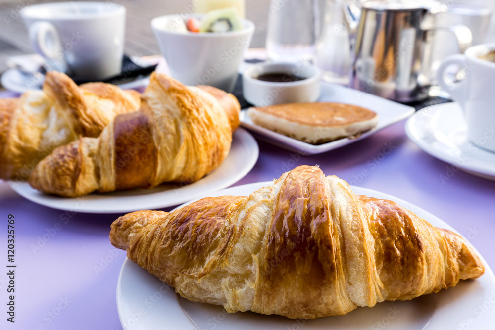 Breakfast with coffee and croissants on table Breakfast with coffee and croissants on table