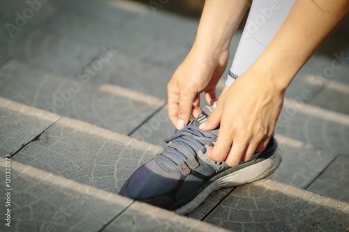 Time to workout. Young woman in the city getting ready for a run.