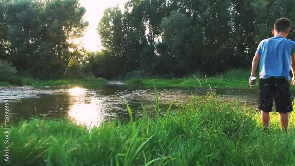aerial shot of two Kids playing at a river in wild nature aerial shot of two Kids playing at a river in wild nature
