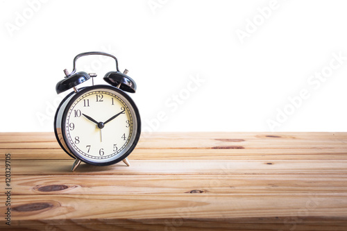 Vintage clock on wooden table over white background