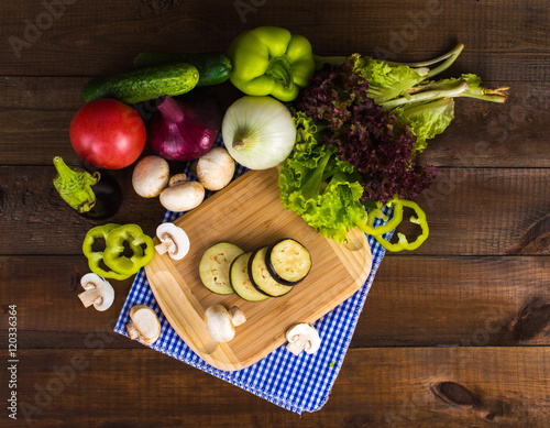 Healthy eating, diet concept - sliced vegetables on a cutting board on a wooden table.