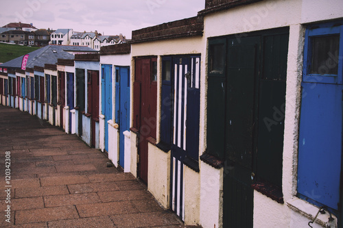 Old disused beach huts on the seafront in Bude Vintage Retro Fil photo