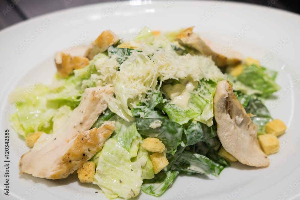 Caesar Salad with grilled chicken on white plate. Caesar Salad with grilled chicken on white plate.