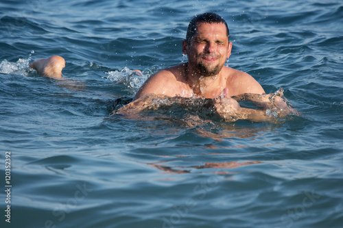 man swimming and water splashing