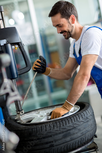 Engineer  replace tire on wheel photo