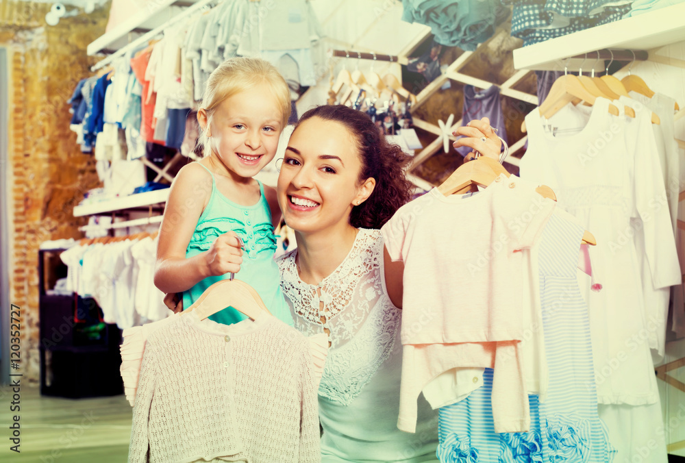 Fototapeta premium Woman with small child in kids apparel boutique