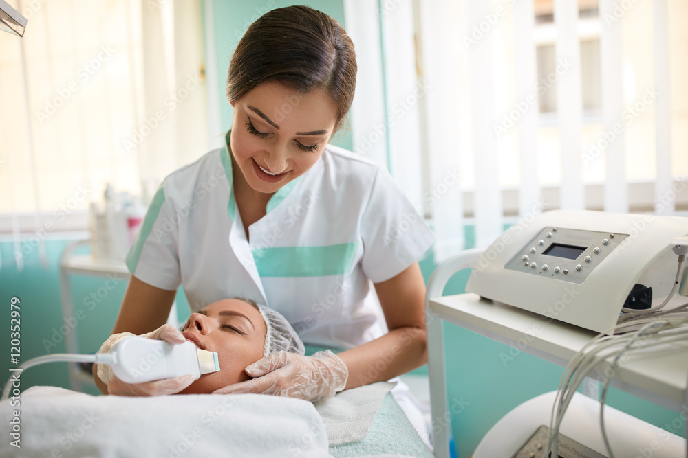 Woman receiving therapy with a professional ultrasonic Woman receiving therapy with a professional ultrasonic