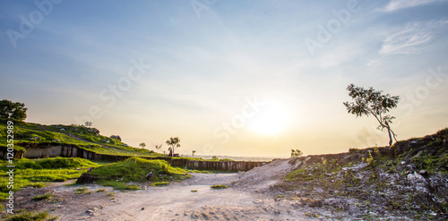 Jaddih white limestone hill, pote mountain in Bangkalan, Madura Island, Indonesia. covered with grass field photo