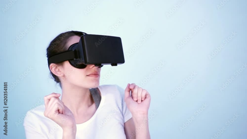 View of a Young attractive woman using a virtual reality headset for first time View of a Young attractive woman using a virtual reality headset for first time